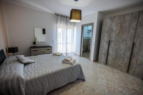 a bedroom with a bed with two towels on it at Sole & Luna Apartment in Marsala
