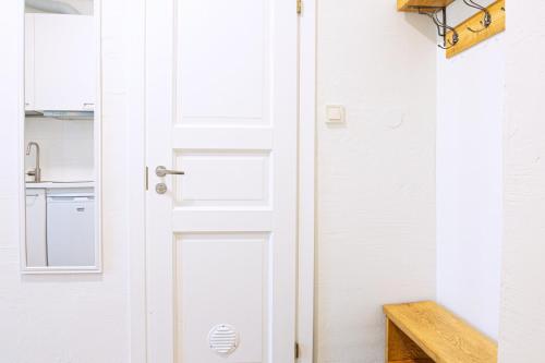a white door in a kitchen with a sink at Kalamaja Park Apartment fast net 150 G, bath in Tallinn