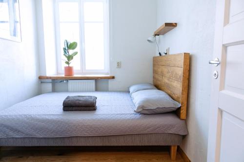 a bed in a small room with a window at Kalamaja Park Apartment fast net 150 G, bath in Tallinn