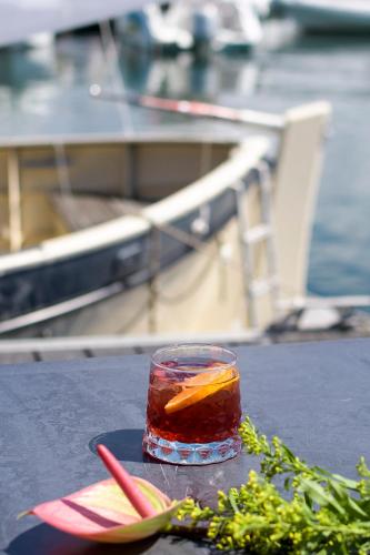 a drink on a table next to a boat at Le Golfe in Porto Pollo