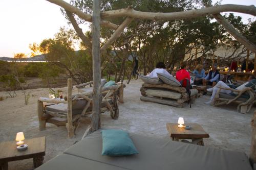 a group of people sitting in chairs and tables at Le Golfe in Porto Pollo