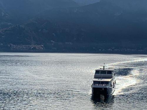 a boat on a large body of water at Zippity Doo Dah - Menaggio Home - Como Lake in Menaggio