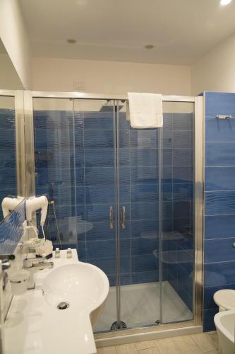 a bathroom with a sink and a glass shower at Hotel Parco Delle Agavi in Ischia