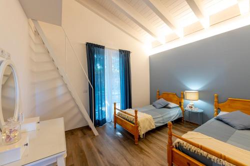 a bedroom with two beds and a window at Dimora Campo delle Mura - Charming House in Acquaviva Picena