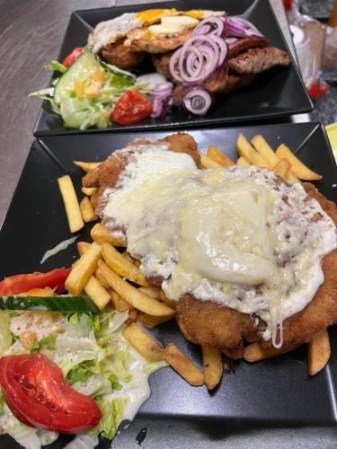 a plate of food with a sandwich and french fries at Gasthof Schönblick Rußbach in Gseng