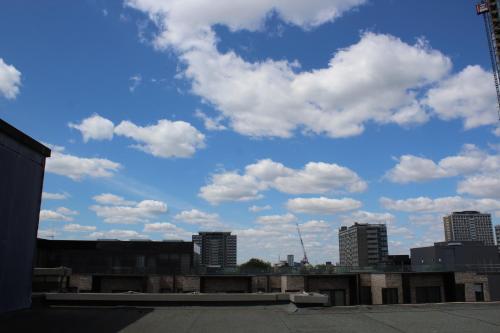 a view of a city skyline with clouds in the sky at Penthouse in Old Street in London