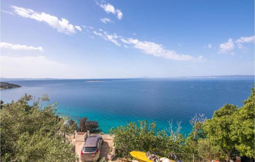 a van parked on a hill next to the ocean at Stunning Apartment In Stara Baska in Stara Baška