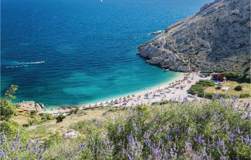 a group of people on a beach near the water at Stunning Apartment In Stara Baska in Stara Baška