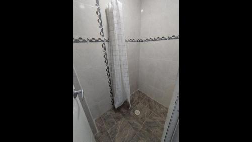a bathroom with a shower with a glass door at Bm-7 room near the sea with air conditioning and WIFI in Cartagena de Indias