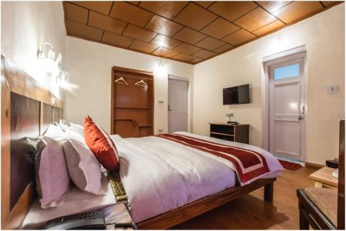 a bedroom with a large bed and a television at Hotel Ri ~ Rab Leh in Leh