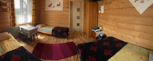 a room with a bed in a wooden cabin at Aśka in Białka Tatrzanska