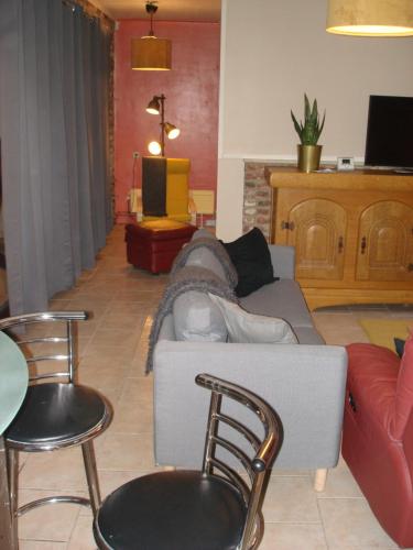 a living room with a couch and two chairs at appartement Courcelles in Courcelles