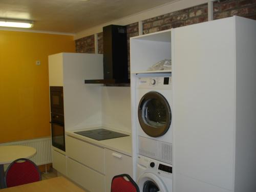 a kitchen with a washer and dryer in a room at appartement Courcelles in Courcelles
