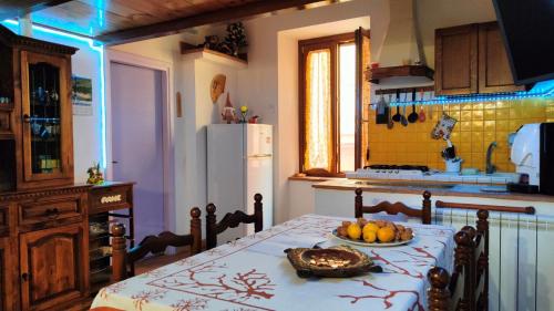 a kitchen with a table with a bowl of fruit on it at A BULLACCO With Parking in Gaeta