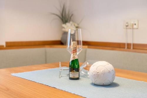a bottle of champagne and a soccer ball on a table at Taufner Apartement C 103 in Parcines