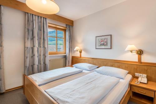 a bedroom with a bed and a window at Taufner Apartement C 103 in Parcines
