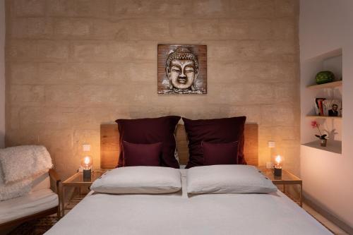 a bedroom with a large bed with two candles at Authentic Maltese 2-bedroom House with Terrace in Żejtun