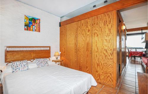 um quarto com uma cama e uma parede de madeira em 1 Bedroom Awesome Apartment In St Cyprien em Saint-Cyprien-Plage