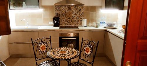 a kitchen with a stove and a table and chairs at Le Altezze in Erice