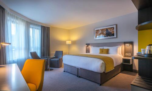 a hotel room with a bed and a desk at Maldron Hotel Pearse Street in Dublin