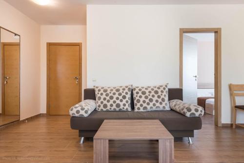 a living room with a couch and a table at Balchik Sea View Apartments in Princess Residence in Balchik