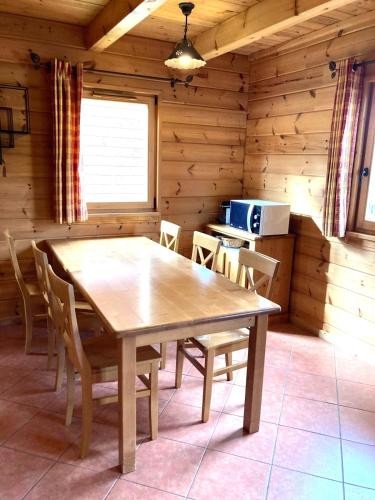 een eetkamer met een tafel en stoelen in een hut bij Chalet les Hauts de la Lauzière in Le Dévoluy