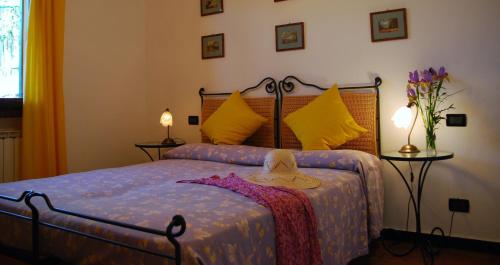 a bedroom with a bed with a hat on it at Agriturismo Benza in Imperia