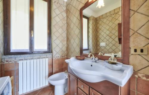 uma casa de banho com um lavatório, um WC e um espelho. em Claudias flat em Lierna