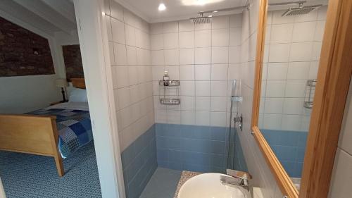 a bathroom with a shower and a sink at ATARAXIA at Saravari Beach-Almond House in Áyios Aléxandros