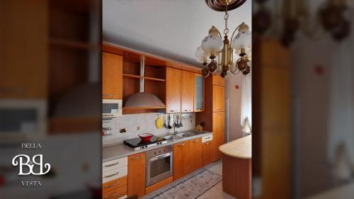 a kitchen with wooden cabinets and a chandelier at Bella Vista B&B in Gissi