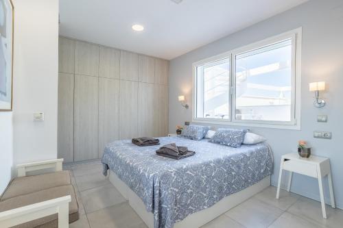 a bedroom with a bed with a large window at Sai Gayatri in Nerja