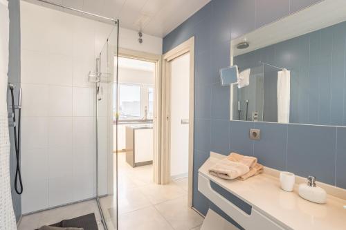 a blue bathroom with a shower and a sink at Sai Gayatri in Nerja
