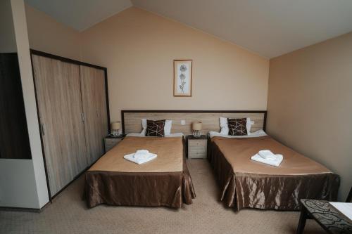 a hotel room with two beds with towels on them at U Ojdanów in Węgrów