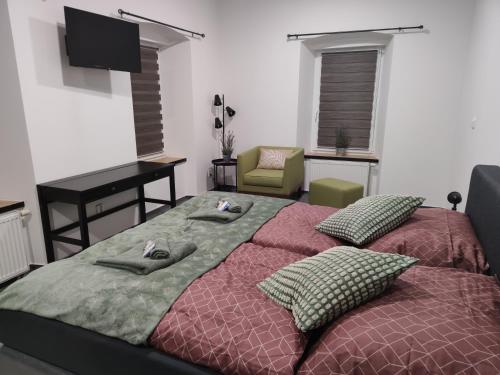 a bedroom with two beds and a table and a desk at B&B Royal Liberty in Ústí nad Labem