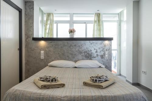 a bedroom with a large bed with two towels on it at Relaxing Cozy Apartment in Nerja
