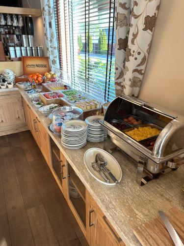 a kitchen with a buffet of food on a counter at Hotel Badura in Wadowice