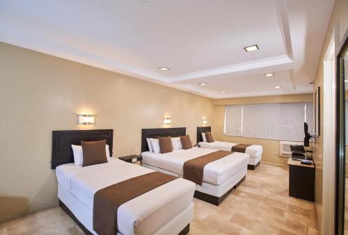 Katil atau katil-katil dalam bilik di Orchid Garden Suites