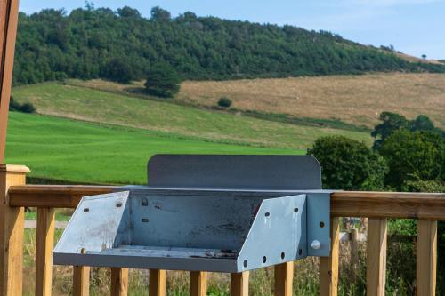 a metal box sitting on top of a wooden rail at Waenfechan Glamping with Hot Tubs in Colwyn Bay