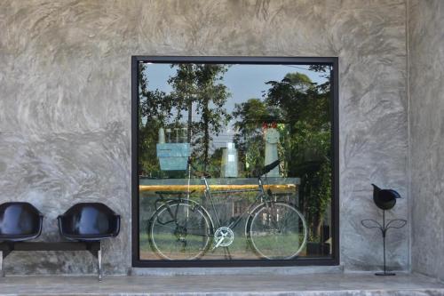 a bike in a window in a room at My Destiny in Ban Wang Muang (1)