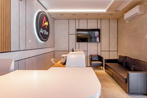 a waiting room with a white table and a couch at AirStar in Surčin