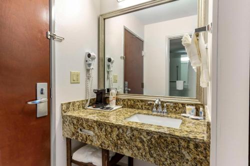 a bathroom with a sink and a large mirror at Comfort Inn Garner Clayton I-40 in Garner