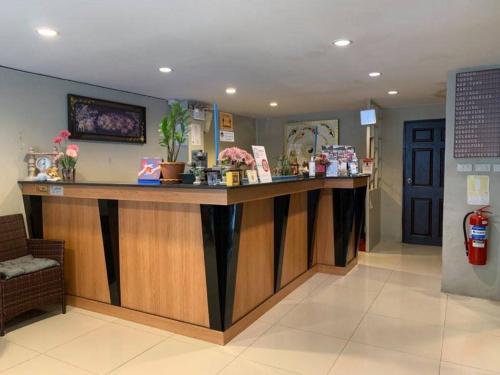 a lobby with a large counter in a room at Green Leaf Hostel in Phuket Town
