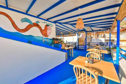 a seafood restaurant with tables and a mural on the wall at Bahar Pansiyon in Antalya