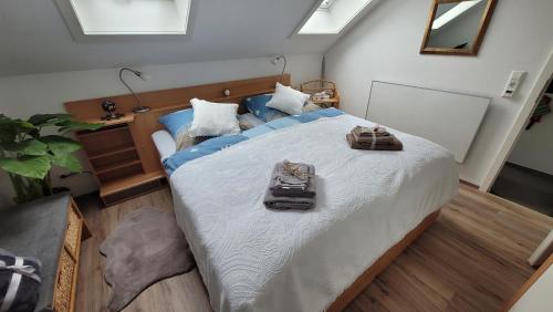 a bedroom with a large bed with shoes on it at Zum Schwalbennest in Todtmoos