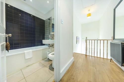 a bathroom with a toilet and a sink at Beautiful Flat in Westminster in London