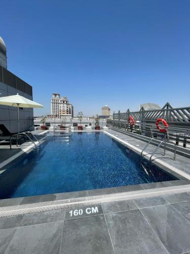 a swimming pool on the roof of a building at MENA ApartHotel Albarsha At The Mall in Dubai