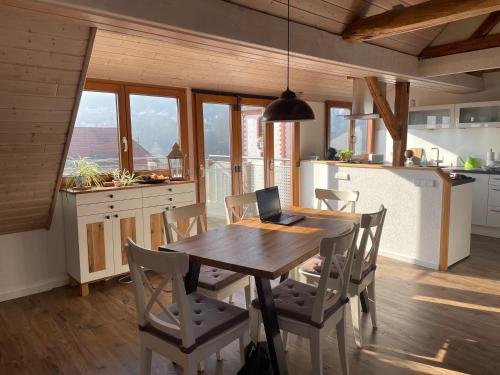 a kitchen with a wooden table with a laptop on it at Sonniges Ferienapartment am Alten Binauer Schloss in Binau
