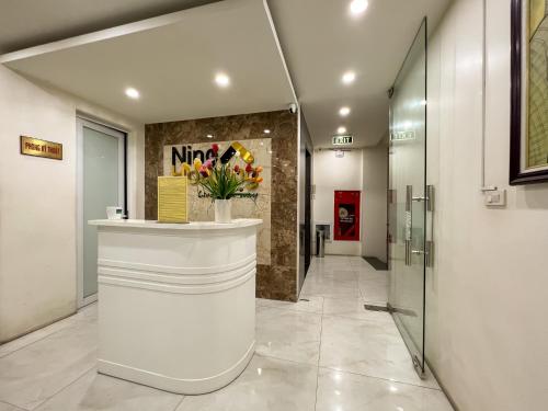 a lobby with a reception desk in a building at NINE HOUSING 92 Dao Tan in Hanoi