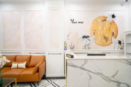 a living room with a couch and a table at SAZI BEN THANH Hotel HCM in Ho Chi Minh City