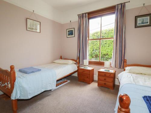 a bedroom with two beds and a window at Beachcliff in Gorran Haven